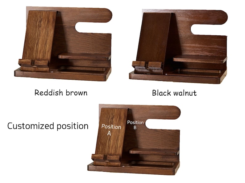 May include: Wooden phone stand with two positions for holding a phone, labelled "Position A" and "Position B". The stand is available in reddish brown and black walnut.