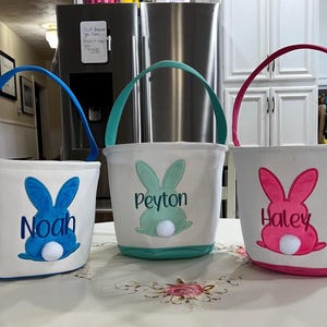 Personalized Easter Basket. Personalized with buyers choice of name. White canvas Easter Basket with  applique, includes tissue paper, bow and clear gift wrapper