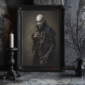 May include: A black framed portrait of a person with pale skin and dark hair wearing a black dress with lace details. The person has a serious expression and is looking directly at the viewer. The portrait is set against a dark background.