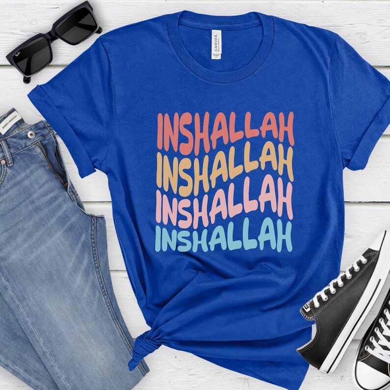 May include: A royal blue t-shirt with the word "Inshallah" repeated four times in a rainbow gradient. The text is in a bold, stylized font.