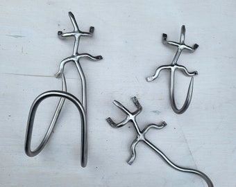 Set of 3 stainless steel lizards, garden hose holder, tools holder, hook.