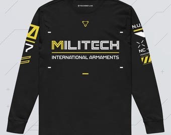 May include: A black long-sleeve shirt featuring the yellow and white text MILITECH INTERNATIONAL ARMAMENTS on the chest. The sleeves display yellow and white geometric patterns and additional text including N.U. and NC. A small logo is at the neck.