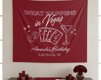May include: A burgundy wall tapestry with white text and illustrations. The text reads "WHAT HAPPENS in Vegas" and "Amanda's Birthday, LAS VEGAS, NV." Illustrations include dice, playing cards, and a martini glass.