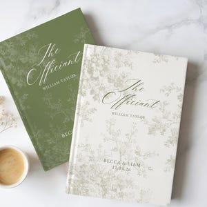 May include: Two hardcover books with floral patterns. The olive green book features the text The Officiant and William Taylor. The cream-colored book features the text The Officiant, William Taylor, and Becca & Liam 11.14.26 in elegant script.