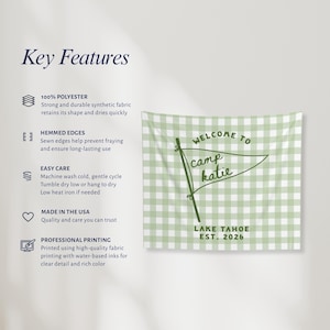 May include: A rectangular wall tapestry featuring a light green and white gingham pattern. The center displays a dark green pennant flag graphic with the text Welcome to camp katie and Lake Tahoe Est. 2026 printed in a dark green sans-serif font.