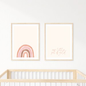 May include: Two framed prints with a pink and brown watercolour rainbow on the left and the text "our little pot of gold" on the right.
