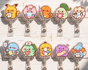 May include: Ten acrylic badge reels featuring cartoon characters in medical attire. Characters include Pikachu with a clipboard, a masked Jigglypuff, Charmander with a syringe, Chikorita with a heart, Togepi with coffee, Squirtle with an IV, Bulbasaur with a heart, Psyduck with pills, Ditto with a bandage, and Mudkip with a clipboard.