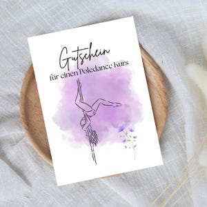 May include: A white gift certificate with the text "Gutschein für einen Poledance Kurs" in black script. The certificate features a line drawing of a person pole dancing against a purple watercolor background, with floral accents.