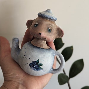 Sleepy mouse in a teapot