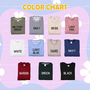 Puede incluir: Una carta de colores que muestra varias sudaderas de cuello redondo en diferentes colores. Los colores incluyen verde militar, gris, beige, rosa claro, blanco, azul claro, arena, azul marino, granate, verde y negro. El texto "COLOR CHART" est&aacute; en la parte superior.