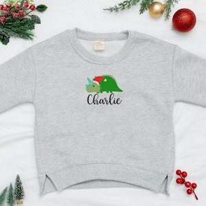 カスタム刺繍の子供用スウェットシャツ恐竜クリスマス、子供用クリスマス スウェットシャツ、クリスマス ベビー スウェットシャツ恐竜、子供へのクリスマス ギフト。
