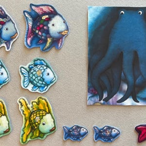 May include: A collection of colorful, whimsical fish and an octopus illustration. The fish vary in color, including blue, yellow, and purple, with detailed scales and fins. The octopus is dark blue with large eyes.
