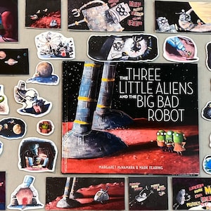 May include: A book cover with a red, orange, and black color scheme. The title is "The Three Little Aliens and the Big Bad Robot." The cover features two large robot legs and three small green aliens.