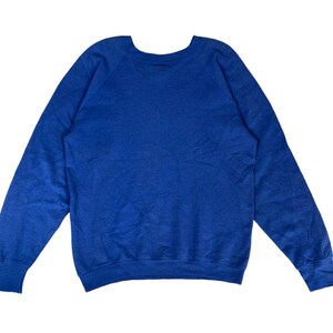 May include: A solid blue sweatshirt with a crew neck and long sleeves.