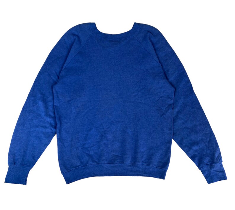 May include: A solid blue sweatshirt with a crew neck and long sleeves.