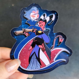 May include: A sticker featuring two cartoon characters, one with blue skin and a white cape, holding a gun, and the other with red skin and a black cape. The characters are set against a blue background with white stars.