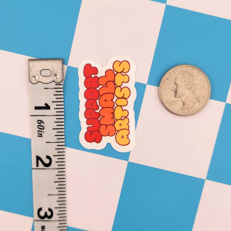 Puede incluir: Una pegatina con el texto "Support Small Artists" en letras de burbujas naranjas y rojas. La pegatina est&aacute; junto a una moneda y una cinta m&eacute;trica. El fondo es un patr&oacute;n de cuadros azules y blancos.