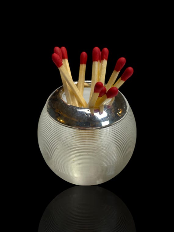 An antique sterling silver and glass match globe. Made in 1901. London, England.