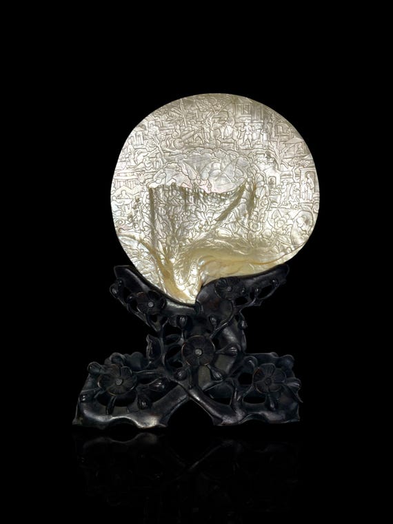 A rare and large museum-grade Qing Dynaasty finely carved pearl shell. With Qing dynasty hand-carved stand.