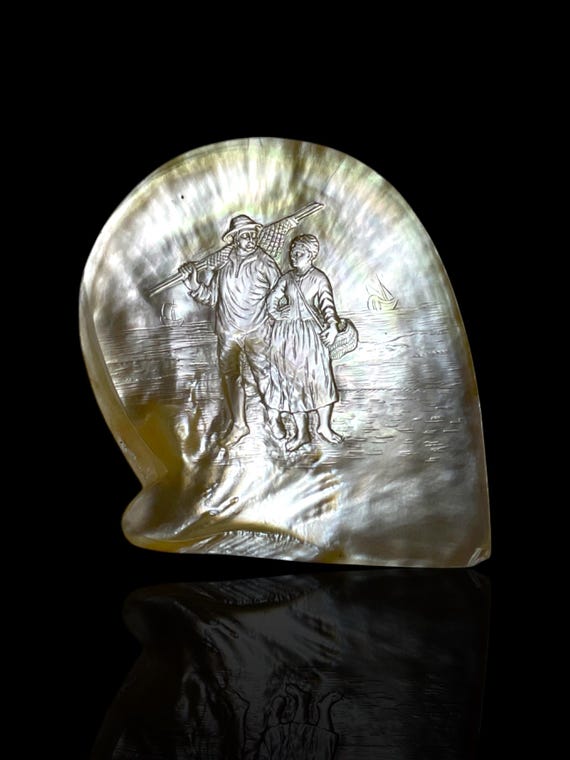 A French Polynesian carved pearl shell. With Stand.