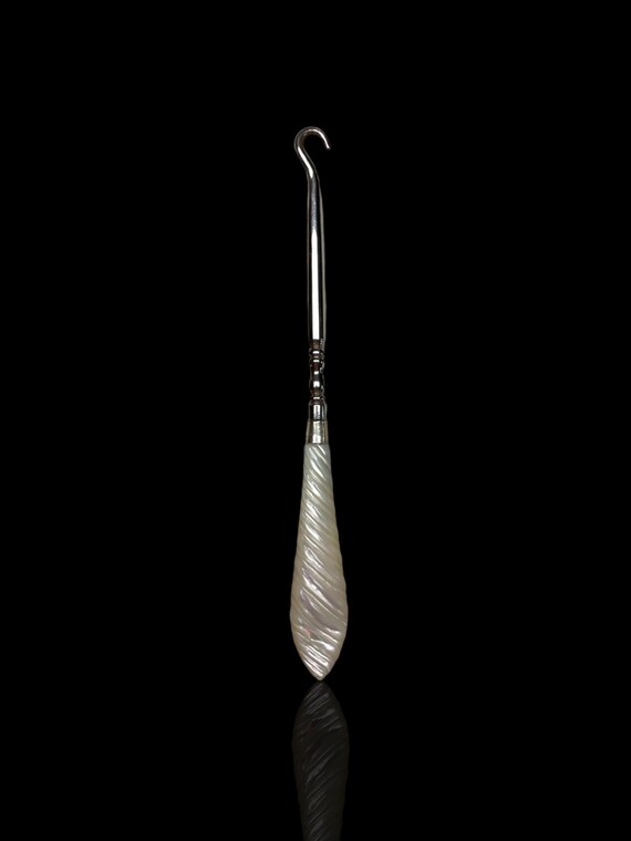 An antique mother of pearl cocktail or drink stirrer. Circa 1930s.
