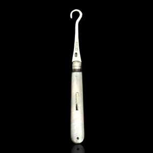 May include: A silver-colored surgical instrument with a curved hook at one end and a long, slender handle. The handle has a smooth, polished finish. The instrument is set against a black background.