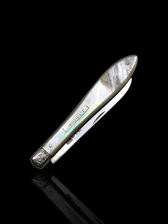 A fine quality folding sterling silver and mother of pearl pocket knife. Made in 1905 by John Edward, England.