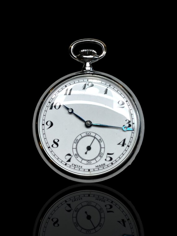 A lovely Swiss made steel pocket watch with desk-clock stand. Working. With removable key chain.