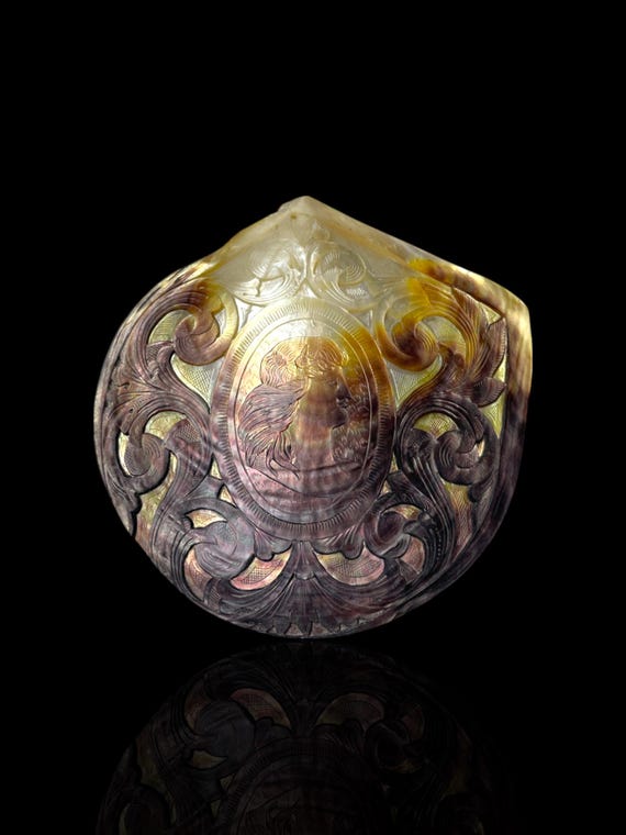 A fine and large convict carved antique pearl shell from Noumea, New Caledonia. Circa 1880. With contemporary stand.