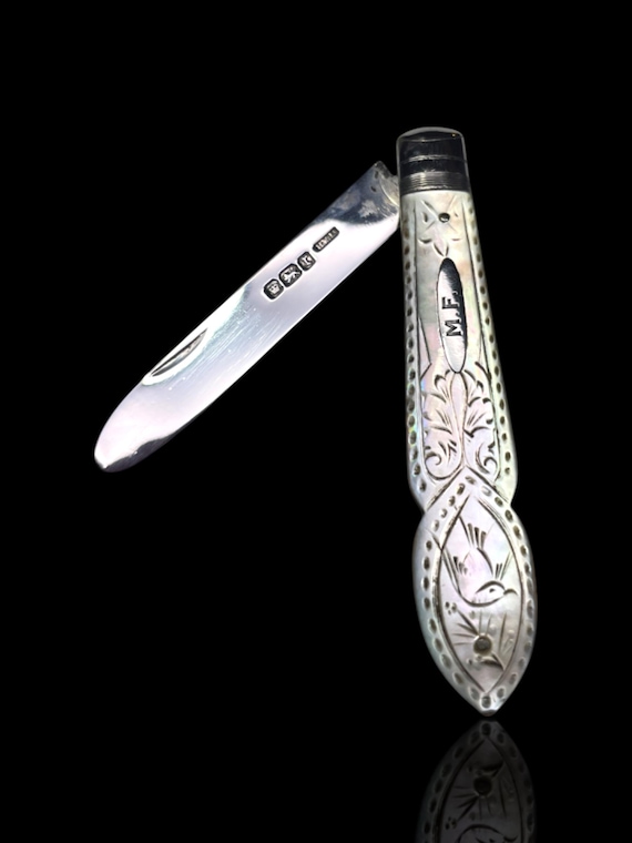 A vintage mother of pearl and sterling silver folding pocket knife. Made in 1909 by English silversmith Henry Williamson.
