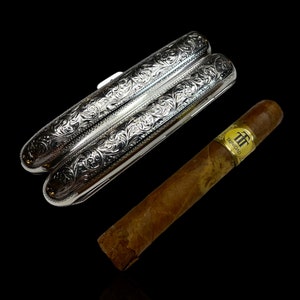 A sterling silver twin cigar case. Made in 1899 by English silversmith Henry Pope.