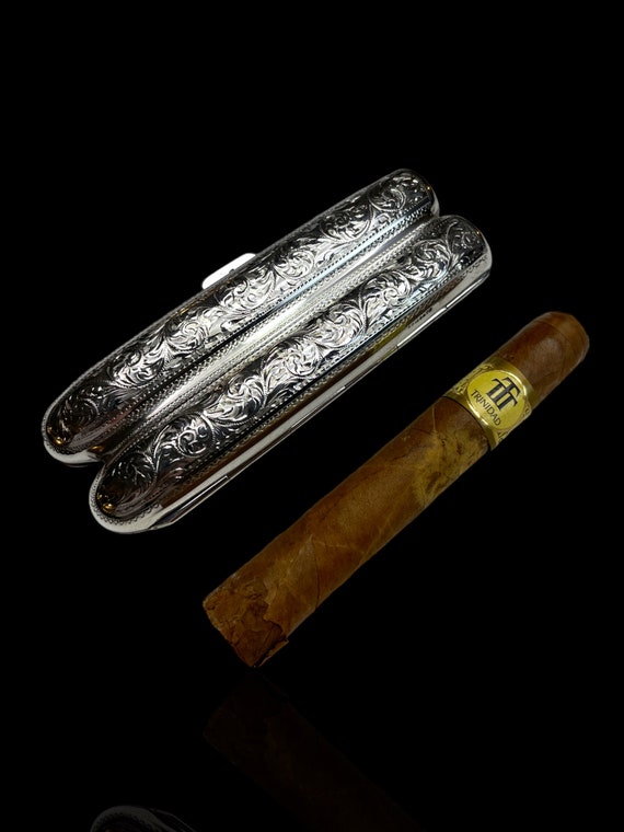 A sterling silver twin cigar case. Made in 1899 by English silversmith Henry Pope.