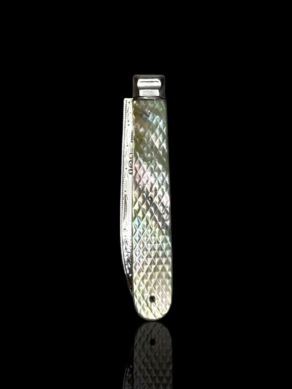 A finely carved antique mother of pearl and sterling silver folding pocket knife. Made in 1893 by English Silversmith Thomas Nowill.
