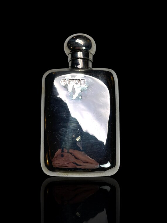 An antique solid sterling silver hip flask. Made in 1897 by Thomas Johnson, England.