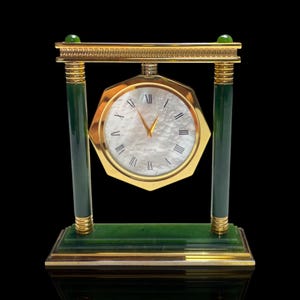 A large Art Deco style mother of pearl, jade and gold plate desk clock. Quartz movement. Good working order.