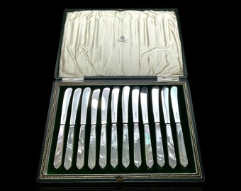 Museum quality mother of pearl and sterling silver butter knives. Dated 1929. Made by famed english silversmiths Edward & Sons. With Case.