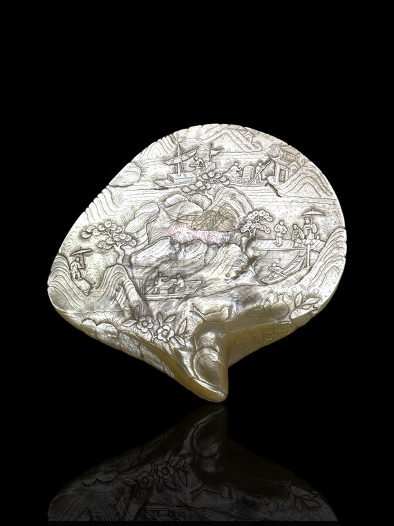 A rare and large museum grade Qing Dynasty finely carved pearl shell. With stand.