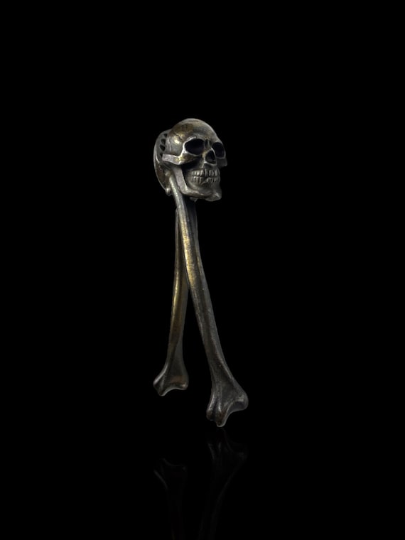 A rare and collectable vintage steel momento mori skull and bones nutcracker. British. Circa 1920s.
