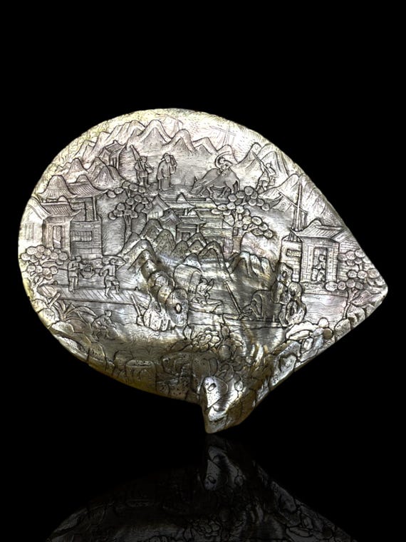 A fine Qing Dynasty carved pearl shell. Approximately 100-140 years old. With stand.