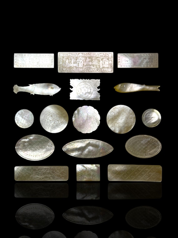 A varied collection of antique mother of pearl gaming counters, hand carved in the 18th and 19th century, ready for framing or setting.