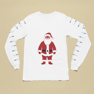 May include: White long-sleeve shirt with a red Santa Claus graphic on the front. The sleeves have a blue and white striped pattern.