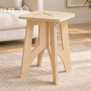 May include: A light-colored wooden stool with a square top featuring a cross-shaped cutout. The stool has four angled legs with open geometric cutouts. Text on the image includes CNC FILES, DIGITAL DOWNLOAD, DXF, SVG, STP, IGS, and Wood Decoded.