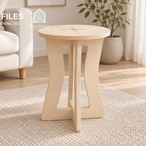 May include: A light-colored wooden side table featuring a circular top with a cross-shaped cutout and a base composed of two interlocking curved panels. The image includes text indicating CNC FILES DIGITAL DOWNLOAD and file formats DXF, SVG, STP, IGS.