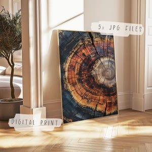 May include: A digital print of a tree trunk cross-section with a circular pattern of concentric rings in shades of brown, orange, and blue. The print is framed in a gold frame and is leaning against a white wall.  5 x JPG FILES - DIGITAL PRINT