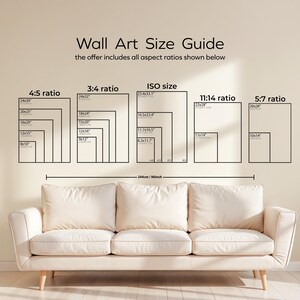 May include: A wall art size guide with various aspect ratios, including 4:5, 3:4, ISO, 11:14, and 5:7, is displayed above a cream-colored sofa. The guide includes measurements in inches and centimeters. The text "Wall Art Size Guide" is at the top.