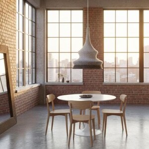 May include: A modern dining room with a white round table and four wooden chairs. A woven pendant light hangs above the table. The room has large windows with a city view and exposed brick walls.