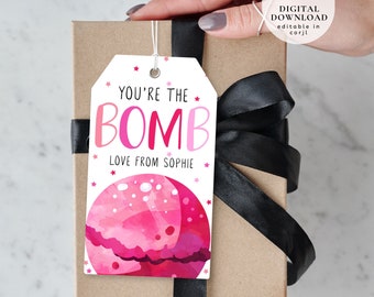 May include: A pink and white gift tag with the text "You're the BOMB Love from Sophie" and a pink watercolor illustration of a bath bomb.