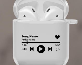 May include: A transparent AirPods case with a black music player graphic. The text on the case reads "Song Name" and "Artist Name." The case is open, displaying white AirPods. The design includes a heart icon and a play/pause button.