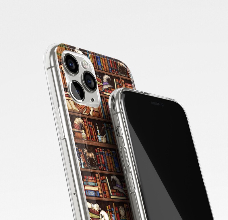 May include: A clear phone case with a design of a bookshelf filled with books, a skull, a hat, and other objects. The case is shown on top of a black phone.