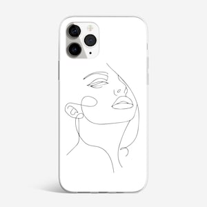 May include: A white phone case with a black line drawing of a woman's face. The woman's eyes are closed and her mouth is open.